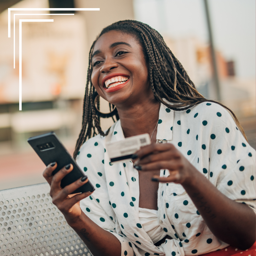 A happy small business owner accepting credit card payment from her phone as a virtual terminal